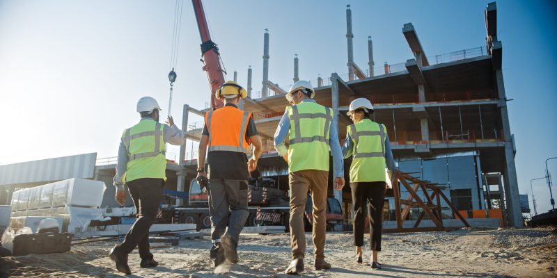 Group of workers in safety gear at a construction site.