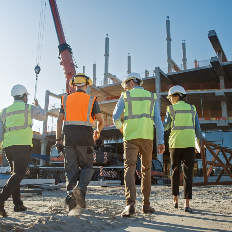 Group of workers in safety gear at a construction site.