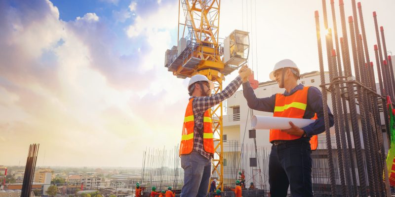 Construction worker with hard hat at a building site.