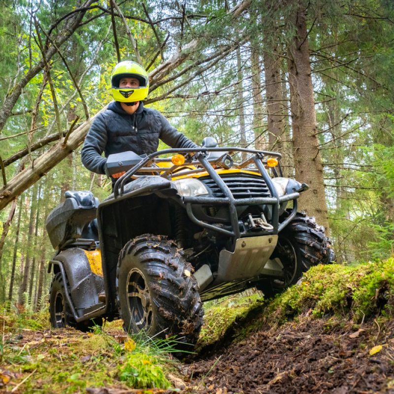 A,Man,In,A,Yellow,Helmet,Rides,A,Quad,Bike